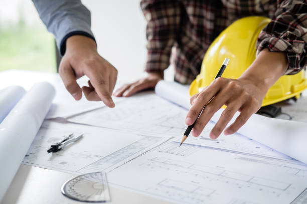 Professional blueprint planning with hard hats
